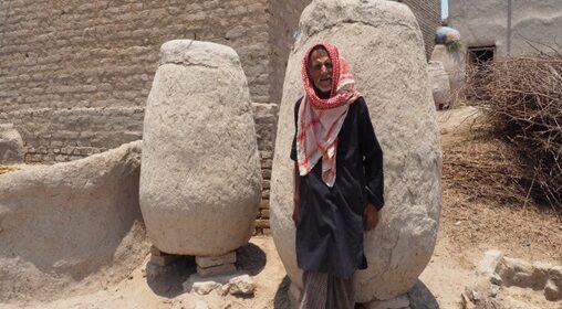 Farmer with his traditional Mud-made bins in a village in Dadu, Sindh in Grain Storage in Spate Irrigated Areas