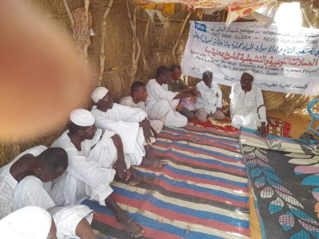 Men meeting inside community house as part of the Reversing the Flow program in Sudan