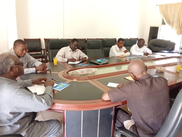 Steering committee meeting around a table, as part of the Community-Led Climate Adaptation