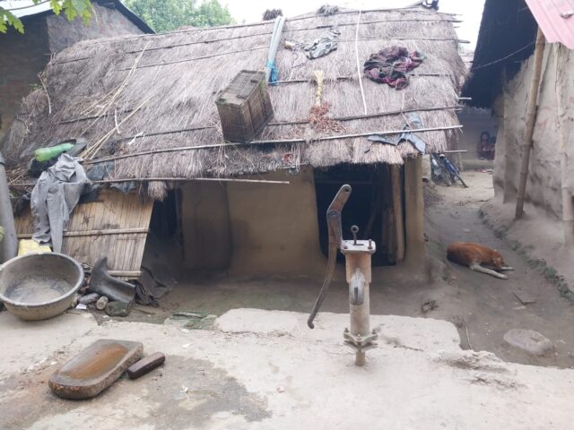 House in Nepal with a hand pump in their doorstep