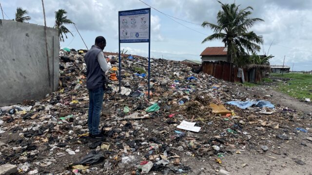 Sam taking notes in his phone on a spontaneous dumpsite